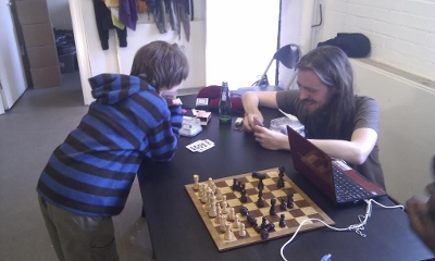 Two people play chess using the heart rate turn timers